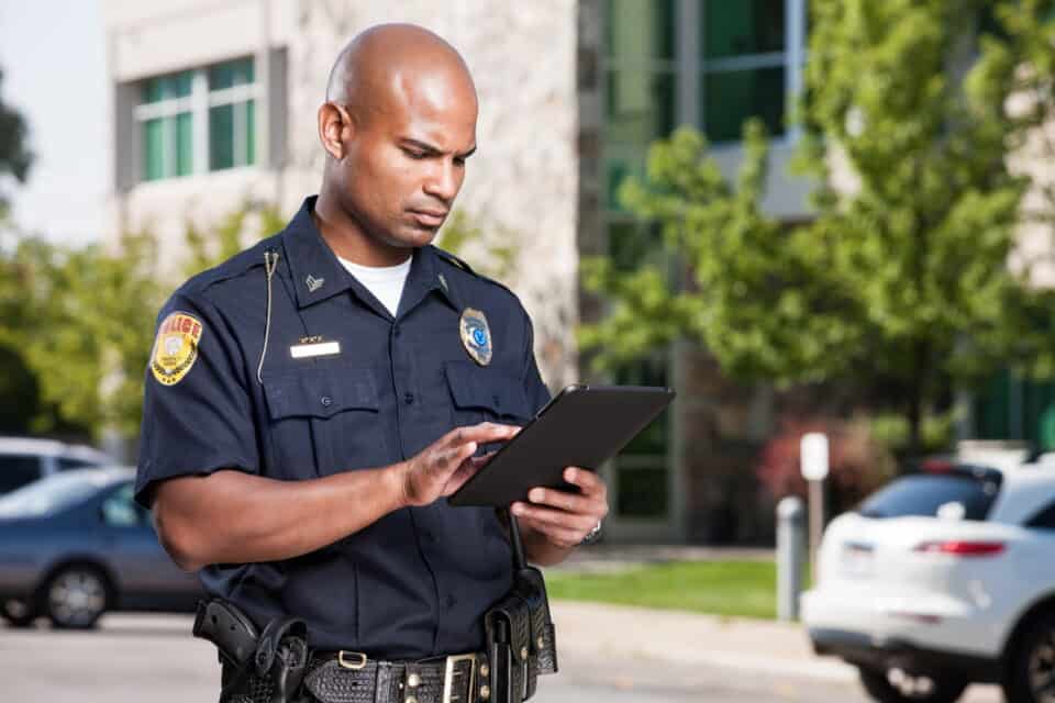 male policeman using an ipad